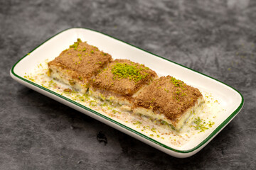 Cold baklava. Baklava with milk on a dark background. Mediterranean cuisine delicacies. Close-up. Local name soguk baklava
