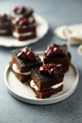 Chocolate cake with cherries and cream