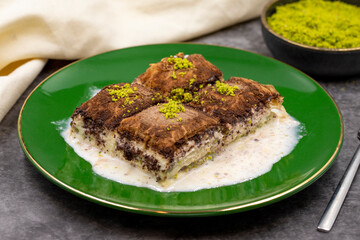 Dark chocolate baklava. Baklava with milk on a dark background. Mediterranean cuisine delicacies. Close-up. Local name bitter soguk baklava