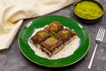 Dark chocolate baklava. Baklava with milk on a dark background. Mediterranean cuisine delicacies. Close-up. Local name bitter soguk baklava