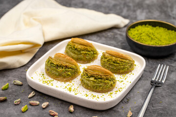 Pistachio baklava. Baklava with pistachio on a dark background. Mediterranean cuisine delicacies. Close-up. local name dilber dudagi baklava
