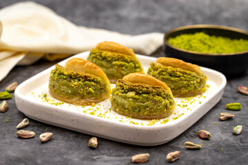 Pistachio baklava. Baklava with pistachio on a dark background. Mediterranean cuisine delicacies. Close-up. local name dilber dudagi baklava