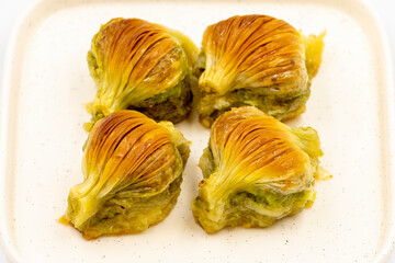 Mussel baklava. Pistachio baklava isolated on a white background. Mediterranean cuisine delicacies. Close-up. local name midye baklava