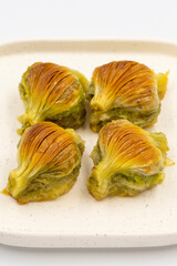 Mussel baklava. Pistachio baklava isolated on a white background. Mediterranean cuisine delicacies. Close-up. local name midye baklava