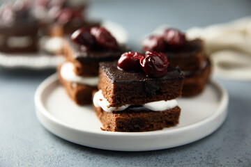 Chocolate cake with cherries and cream