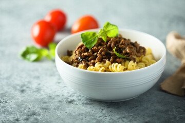 Pasta with minced meat and green basil
