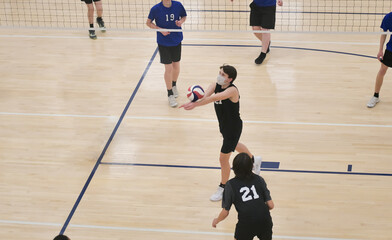 Volleyball player bump setting the ball in a sixes game