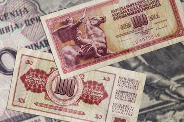 Top view of red old damaged weathered Yugoslavian 100 dinars banknotes - obrazy, fototapety, plakaty