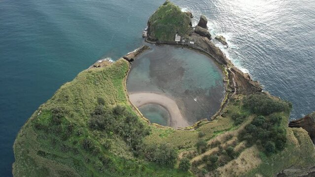 Famous volcanic islet of Vila Franca do Campo, small green crater island near sea shore with rocks ocean, Sao Miguel, Azores, Portugal