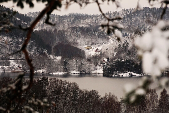 Frozen lake or river covered with white snow in the forest in winter in Larvik, Norway
