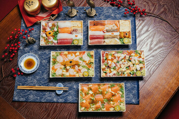 Asoorted japanes food Sashimi Seafood Don, chirashi sushi, Arashi shrimp, sea urchin sushi, salmon don, Sashimi Seafood Don, donburi in a dish with chopsticks isolated on mat side view of taiwan food