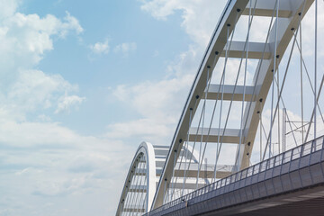 Modern metal bridge against the blue sky background.