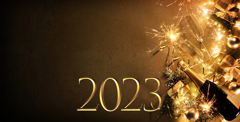 New Years Eve holiday background with fir branches, number 2023, champagne bottle, christmas balls,...