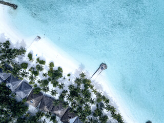 Aerial view from drone white beach and crystal clear sea, Maldives.
