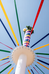 Low angle shot of a pole with colored ribbons on a traditional English Maypole dancing day