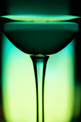 Cocktail drink on a green background. Blue drink. Selective focus.