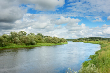 Fototapeta na wymiar The nature of Belarus - a calm summer landscape on the banks of the Berezina River