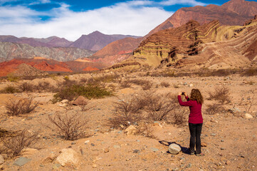 Woman photographing landscape in Salta region, Argentina