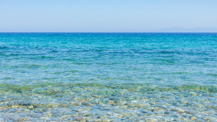 Turquoise sea and blue sky. Landscape with sea waves at a summer resort. Summer holiday concept
