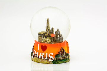 Closeup shot of a Paris Eiffel Tower snow globe souvenir isolated on a white background