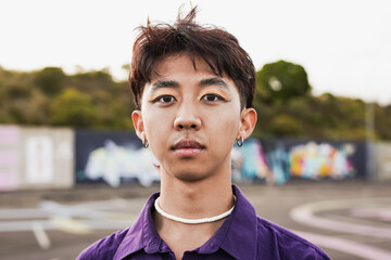 Young asian man with make up looking on camera