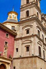 Back facade of the Church of Santo Domingo in Murcia made of brick, with towers and arches