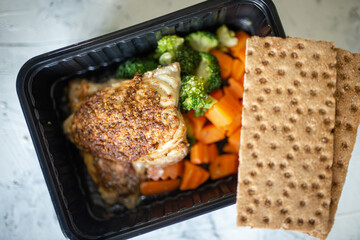 grilled chicken fillet with broccoli, carrots and vegetables and bread