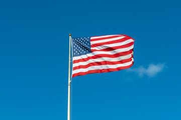 American flag in front of blue sky