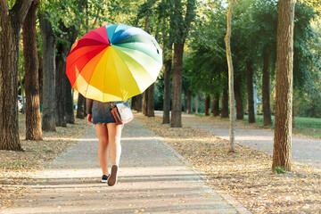 Unrecognizable woman with rainbow umbrella