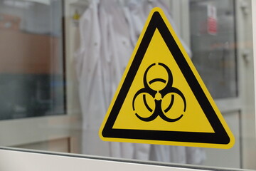 Biological hazard sticker on the doors to cell culture laboratory. Biohazard is a biological...