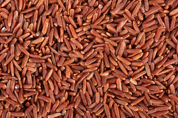 Red rice background. Whole grain raw brown rice. Top view.