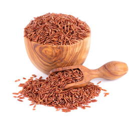 Red rice isolated in olive bowl and scoop, on white background. Whole grain raw brown rice.