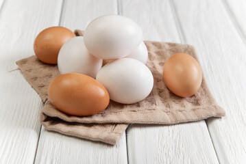 Several eggs on a towel on a white background