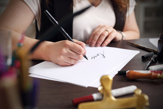 Calligraphy, woman writes with a fountain pen.