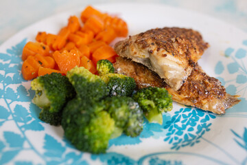 chicken fillet with assorted vegetables. cauliflower, broccoli and carrots on a beautiful plate