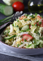 Salad with Chinese cabbage, tomatoes, chives, eggs and cucumber, dressed with olive oil, Close-up
