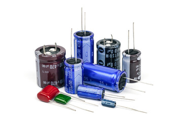 Group of capacitors different sizes isolated on white background.                        - obrazy, fototapety, plakaty