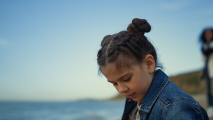 Young girl enjoying beach sunny day on family vacation. Cute kid playing outdoor