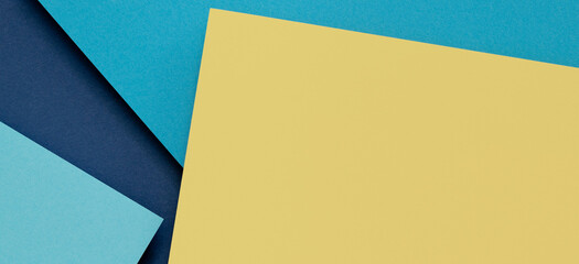 Abstract color papers geometry flat lay composition banner background with light blue and pastel yellow tones
