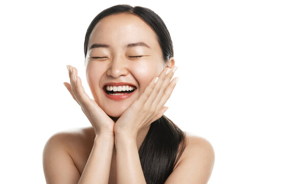 Beauty And Spa. Asian Woman With Healthy Facial Skin, Splash Water, Rinse Face, Clear Skin With Cleansing Gel And Laughing, Standing Over White Background