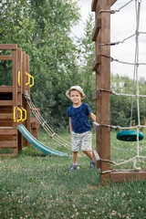 A happy child is running around on his playground on a sunny summer day