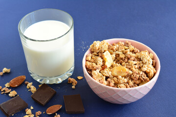 morning breakfast with bowl of banana granola and glass of milk, close-up