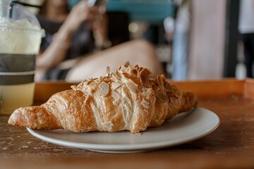Woman is having croissant and iced lemon tea in the cafe. High quality photo
