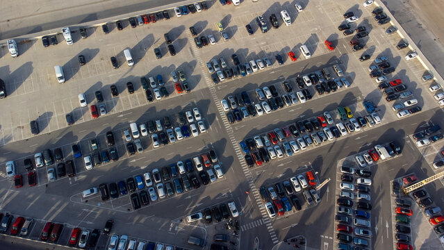 Aerial view of a shopping center parking lot. Drone photography of the vehicles in the parking lot.