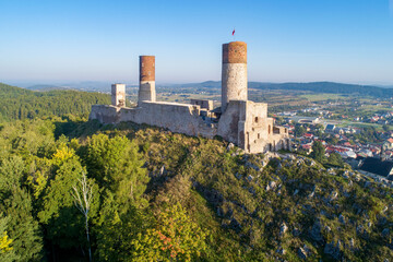Fototapeta premium Medieval royal castle in Checiny near Kielce in Poland. Built in late 13th century. Ruin partly renovated. Aerial view in sunrise light.