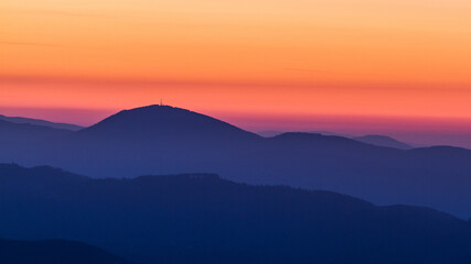 Fototapeta na wymiar Colorful sunrise over the Schoeckl mountain near Graz in Austria