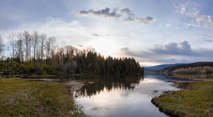 Panoramic View of a Canadian Landscape in Shoreline Trail, Port Moody, Greater Vancouver, British Columbia, Canada. Park in a Modern City during a colorful Sunset Sky. Nature Background Panorama