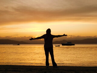 Women Open Armas on a Sunset