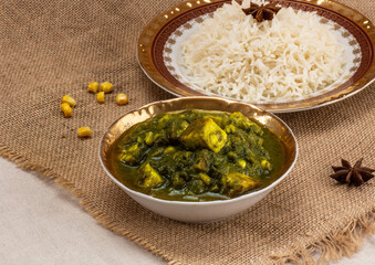 Two plates with delicious Indian food. Green spinach, yellow corn and pale white rice