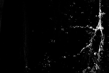 water splashes isolated on black background. white jets with drops